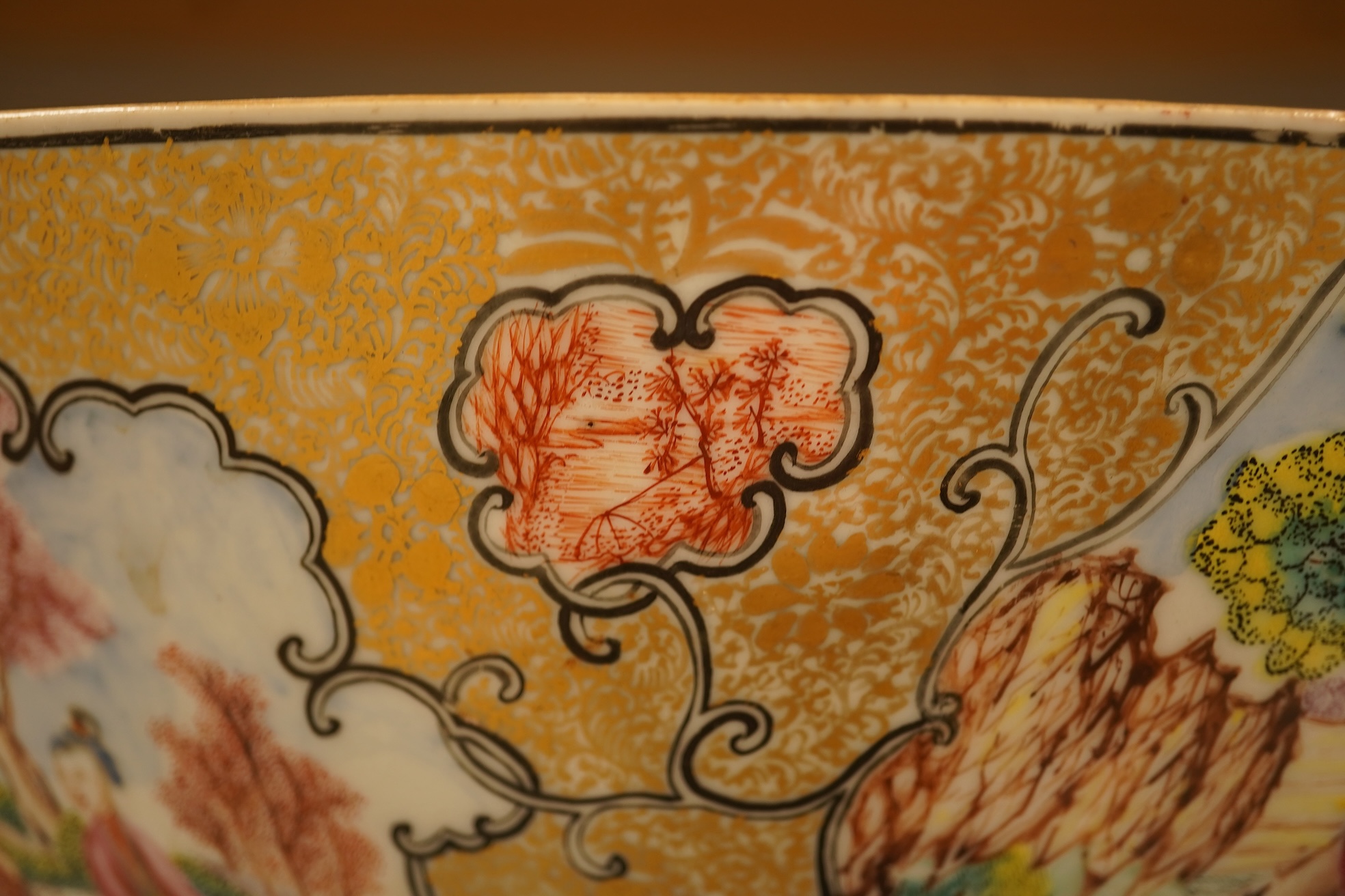 An 18th century Chinese famille rose figural bowl, on wooden stand, 34cm diameter.